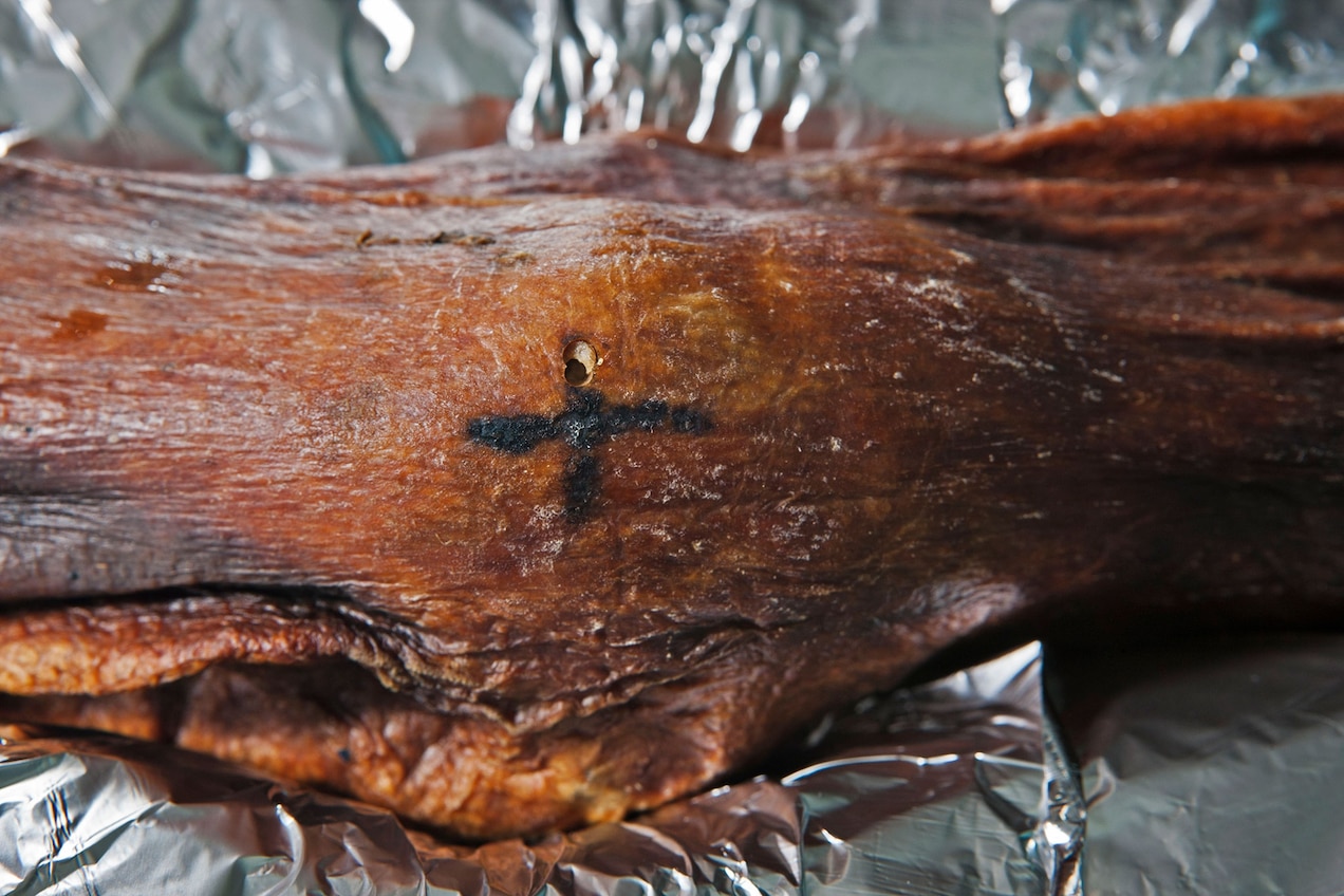 Ötzi's body bears more than 60 tattoos, including this cross-shaped tattoo near his knee.  