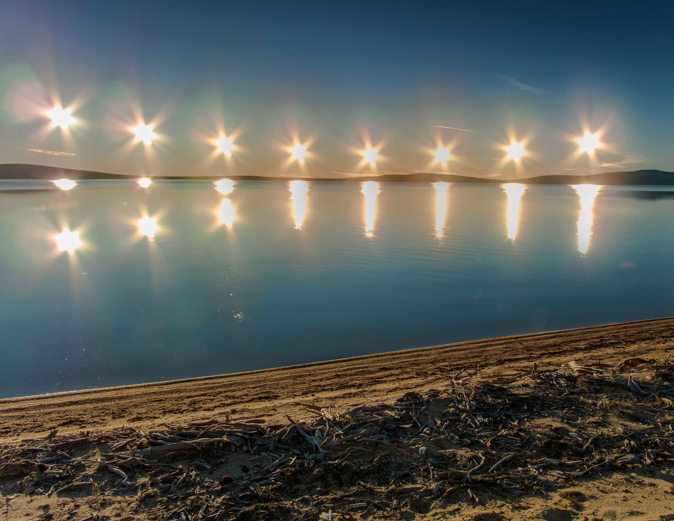 midnight sun Multiple exposure of midnight sun on Lake Ozhogino in Yakutia, Russia
